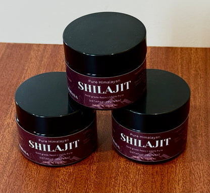 Three jars of Pure Himalayan Shilajit on a wooden surface