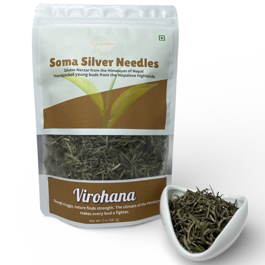 Soma Silver Needles tea package with a small white dish of tea leaves on a white background