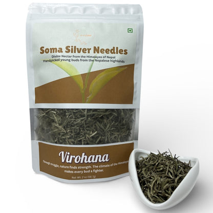 Soma Silver Needles tea package with a small white dish of tea leaves on a white background