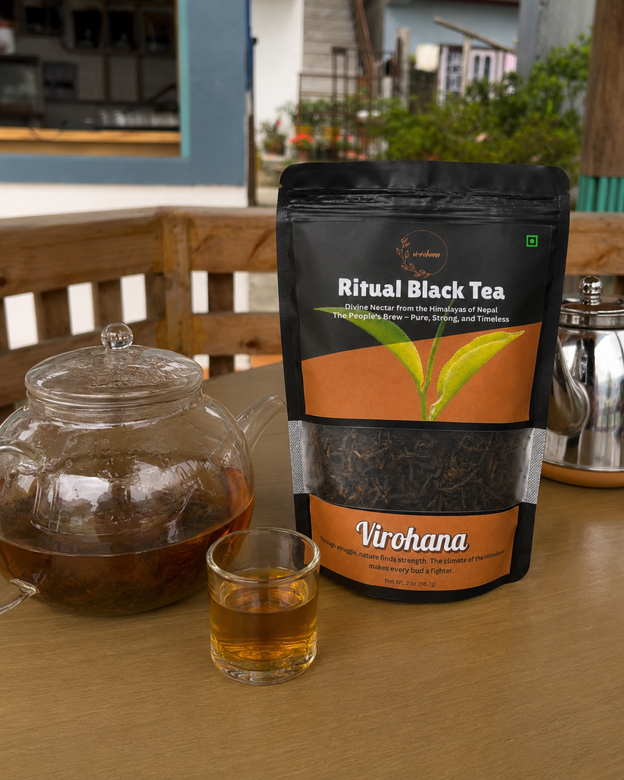 Tea bag packaging of 'Ritual Black Tea' by 'Virohana' with a glass teapot and cup on a wooden table.