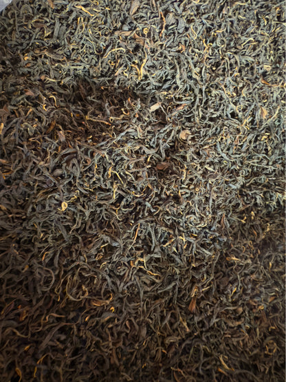 Close-up of dark brown and green tea leaves.