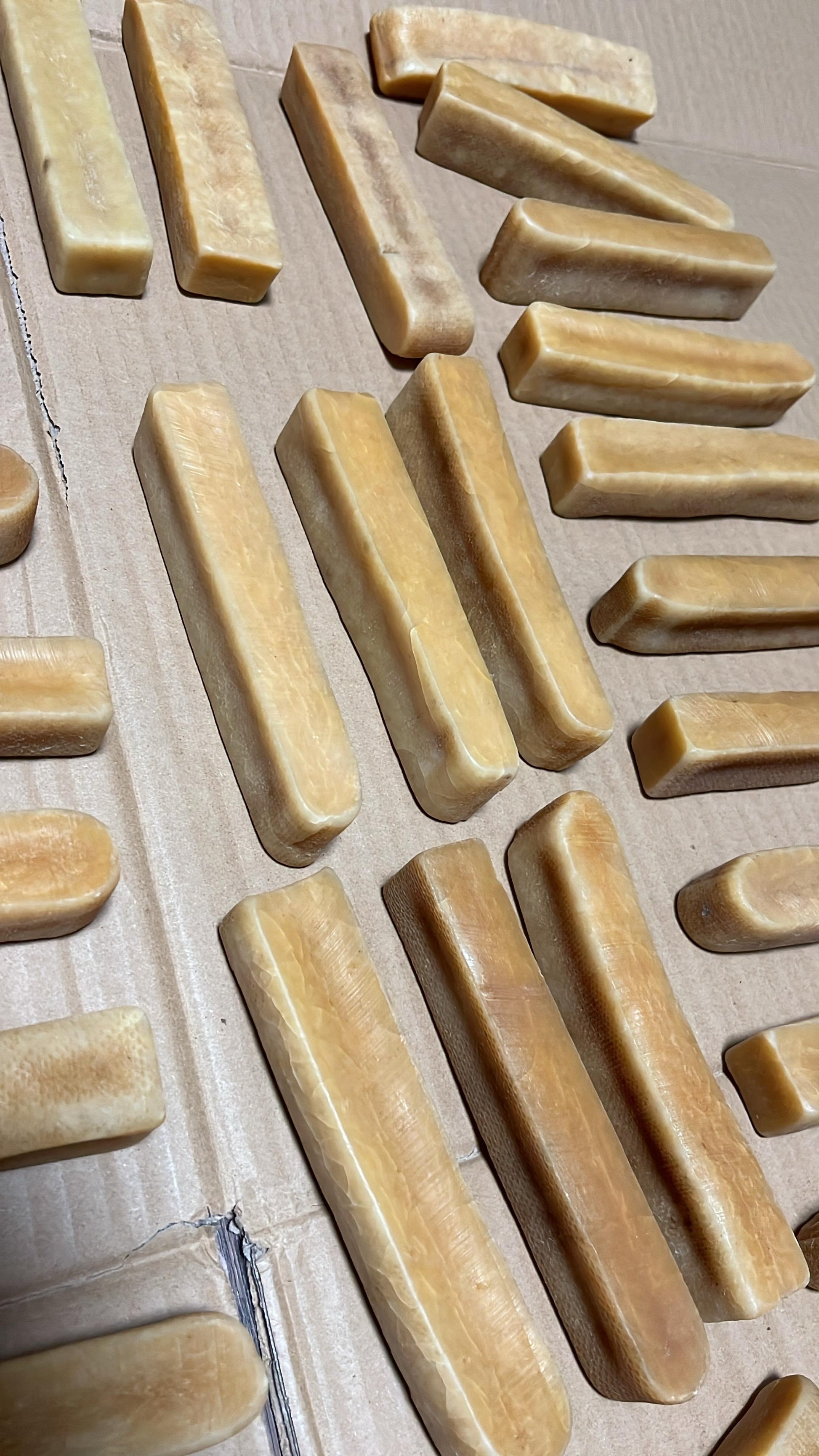 Cheese of various sizes on a wooden surface