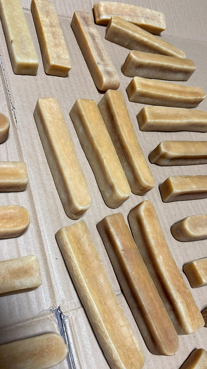 Cheese of various sizes on a wooden surface
