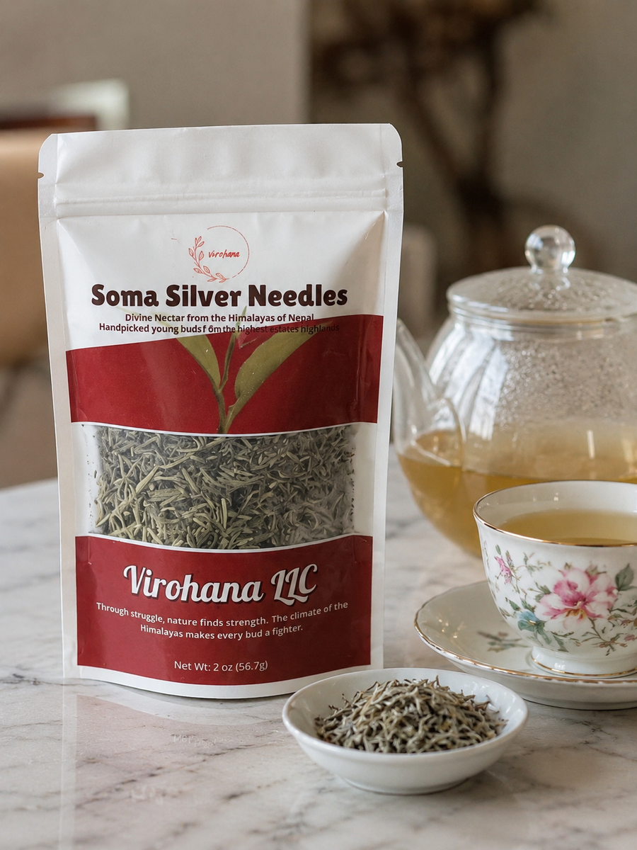 Packaging of Soma Silver Needles tea with a teacup and teapot in the background.